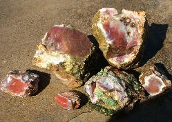 Rough carnelian paint rock agate exhibiting patination , which is an outer white exterior that conceals the inner color.